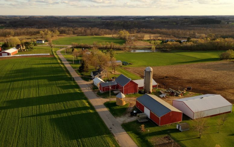 Aerial view of farmland and barns.